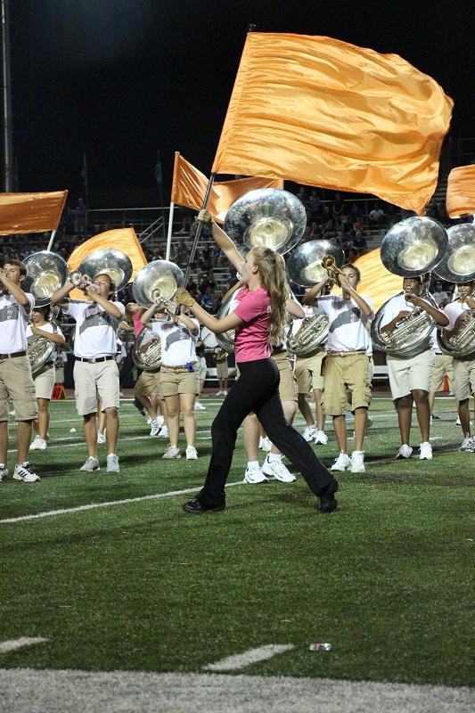 Sophomore Caroline Landers spins her flag in time with the rest of the band.