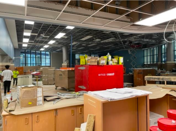 Construction workers, along with jumbled cardboard boxes, line the room as the FMHS library undergoes long awaited renovations.