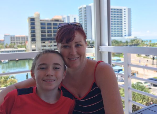 My mom and I sit on a balcony in a beachside restaurant in Clearwater, Florida. This picture was taken by my father on vacation in 2017, when I was 11.