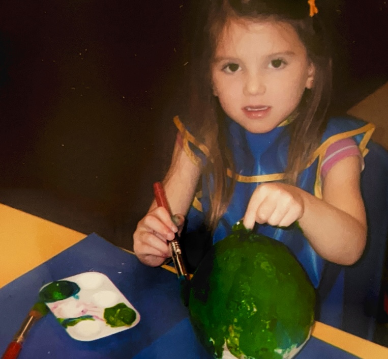 Me, when I was three years old, painting a paper mache sphere in preschool.